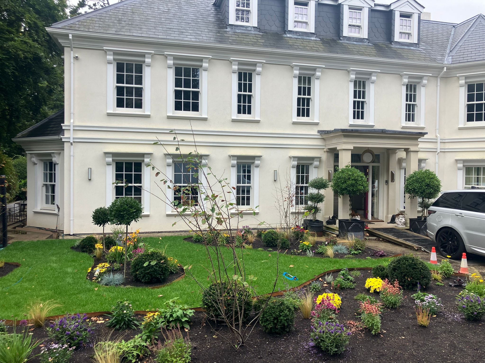 Landscaped house front with topiary standards